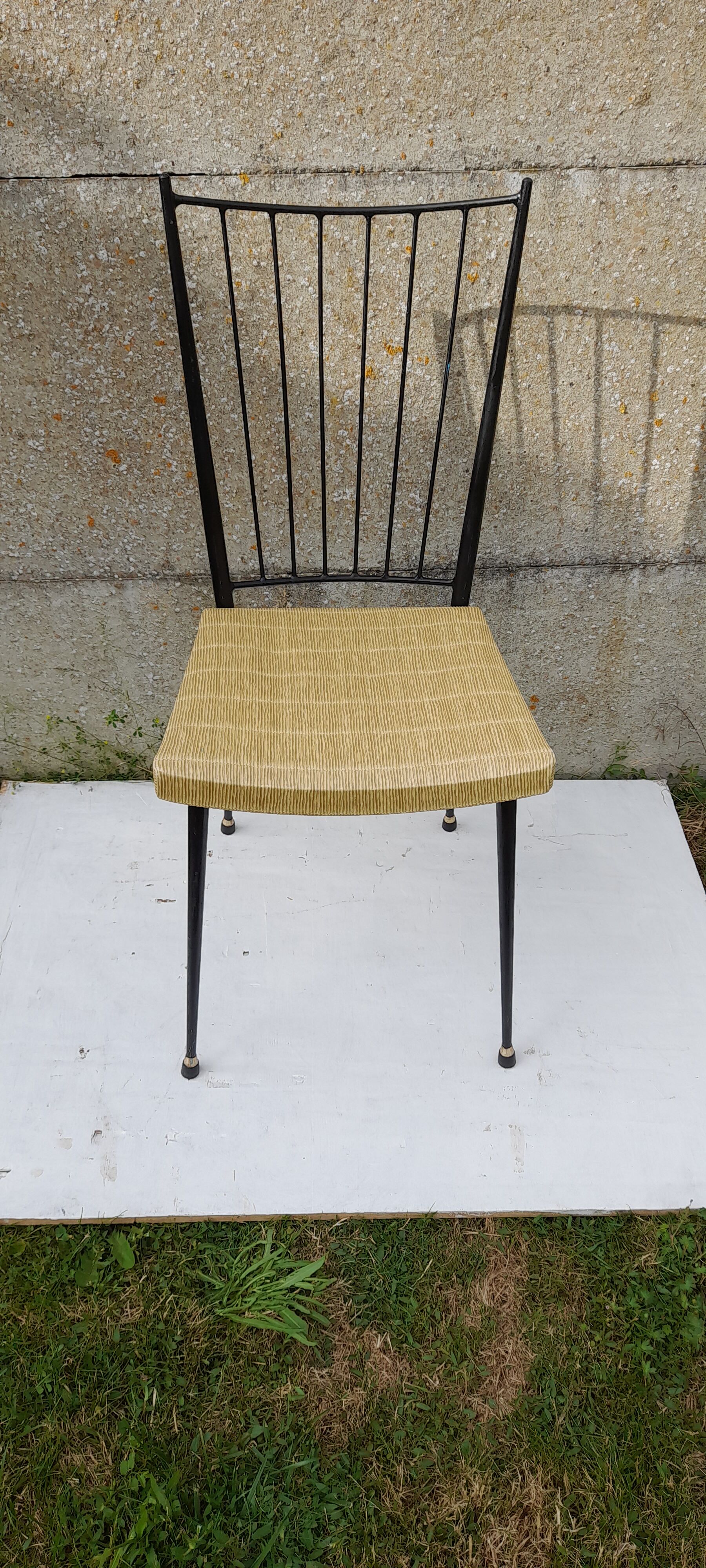 Black metal chair and yellow imitation leather seat