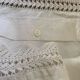 Antique white cotton pillowcase with crochet and monogram.