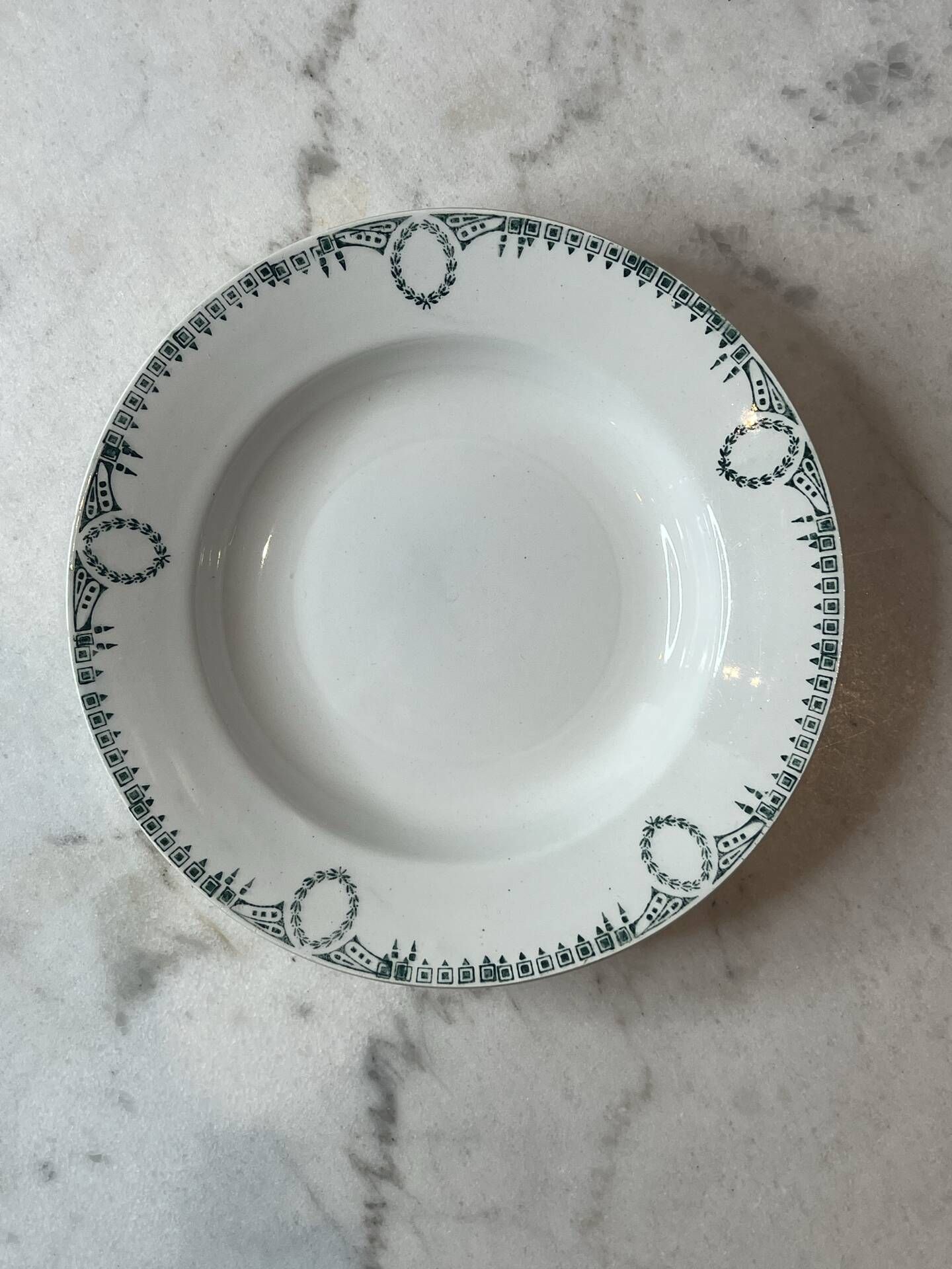 Set of 4 deep plates from Saint Amand with laurel wreath decoration.