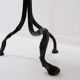 Large wrought iron candelabrum with an abstract design and three candle holders.