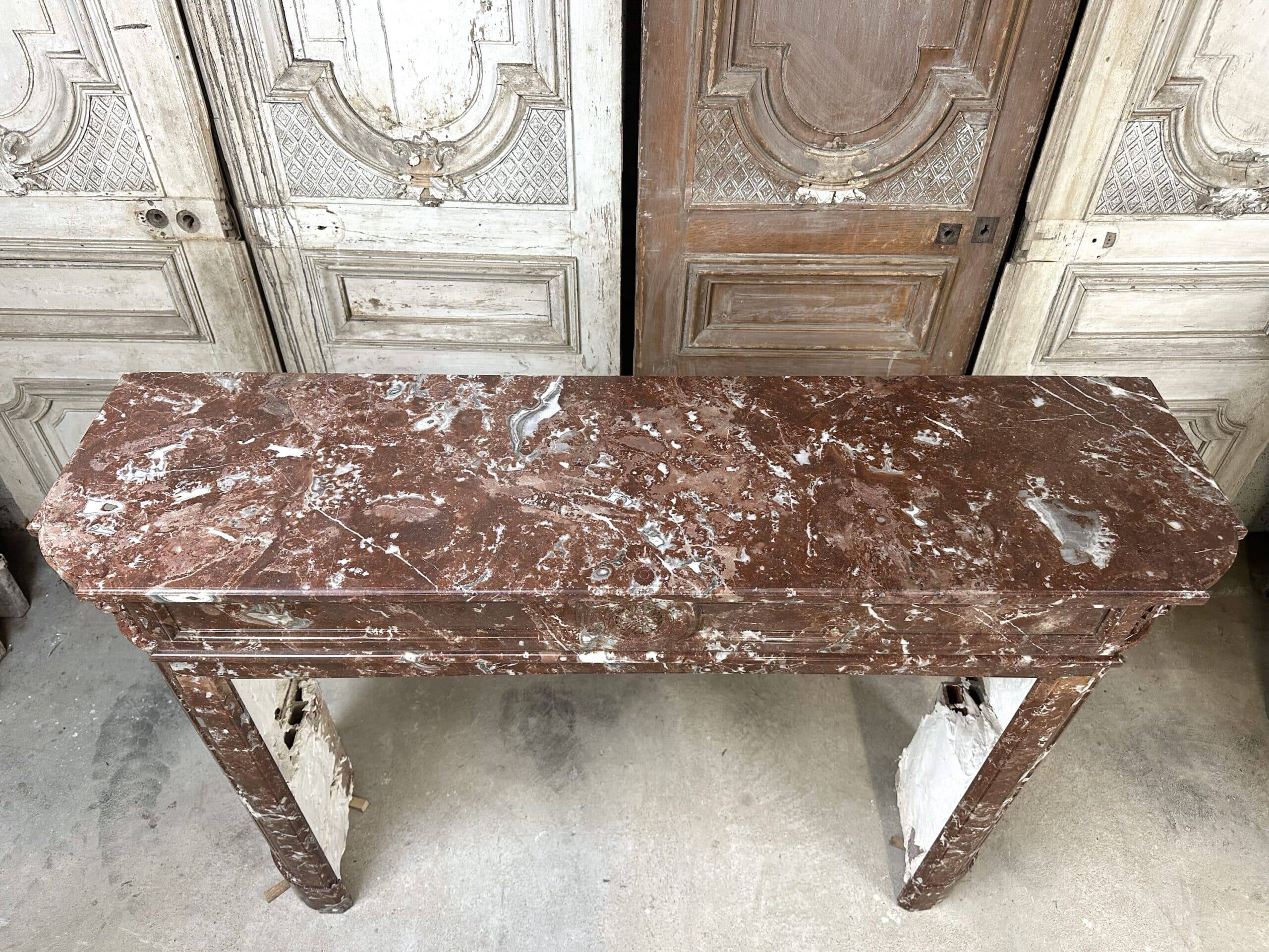 Red marble fireplace in the Louis XVI style, late 19th century