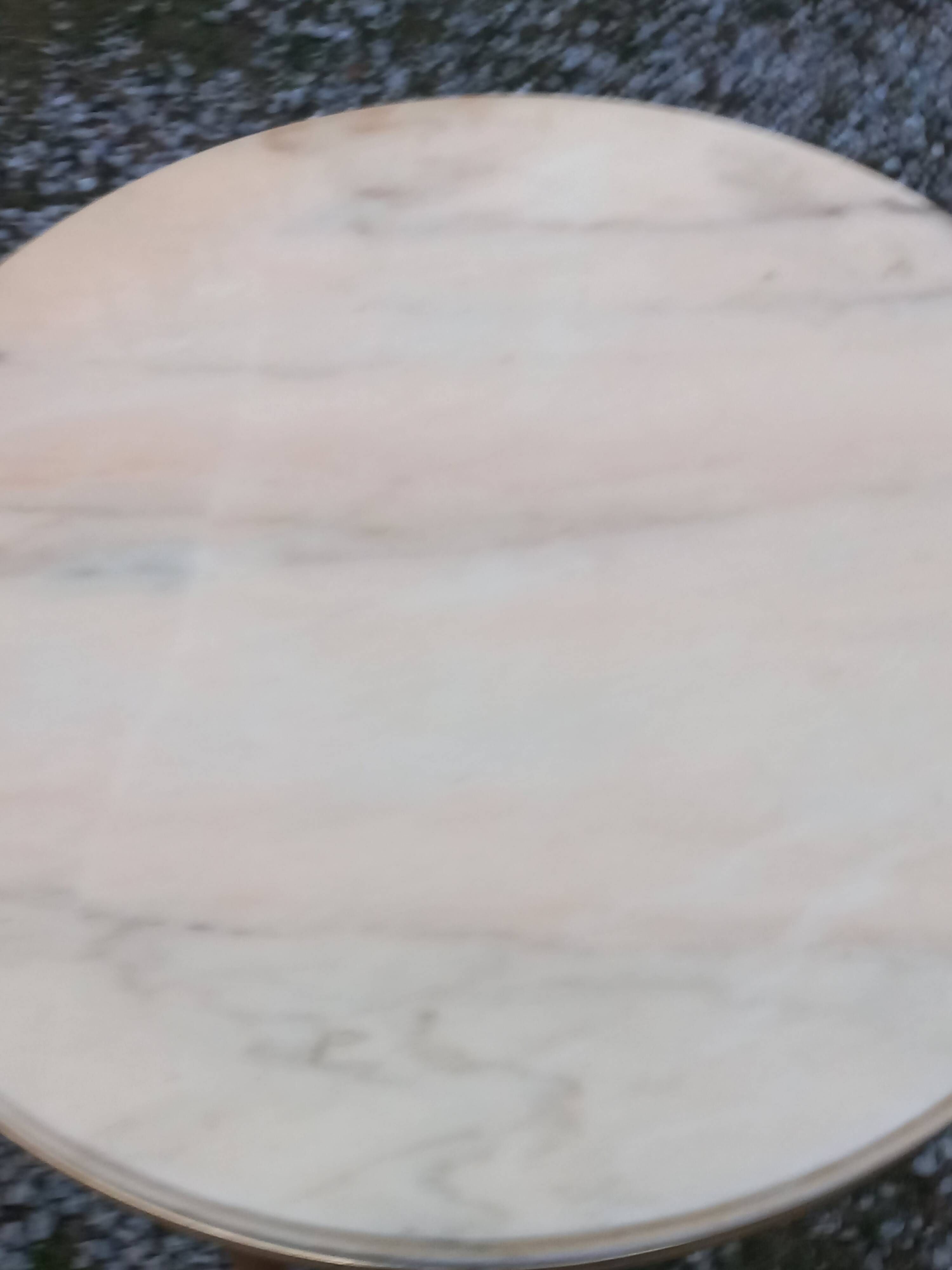 Round neoclassical coffee table with a marble top and golden metal base.