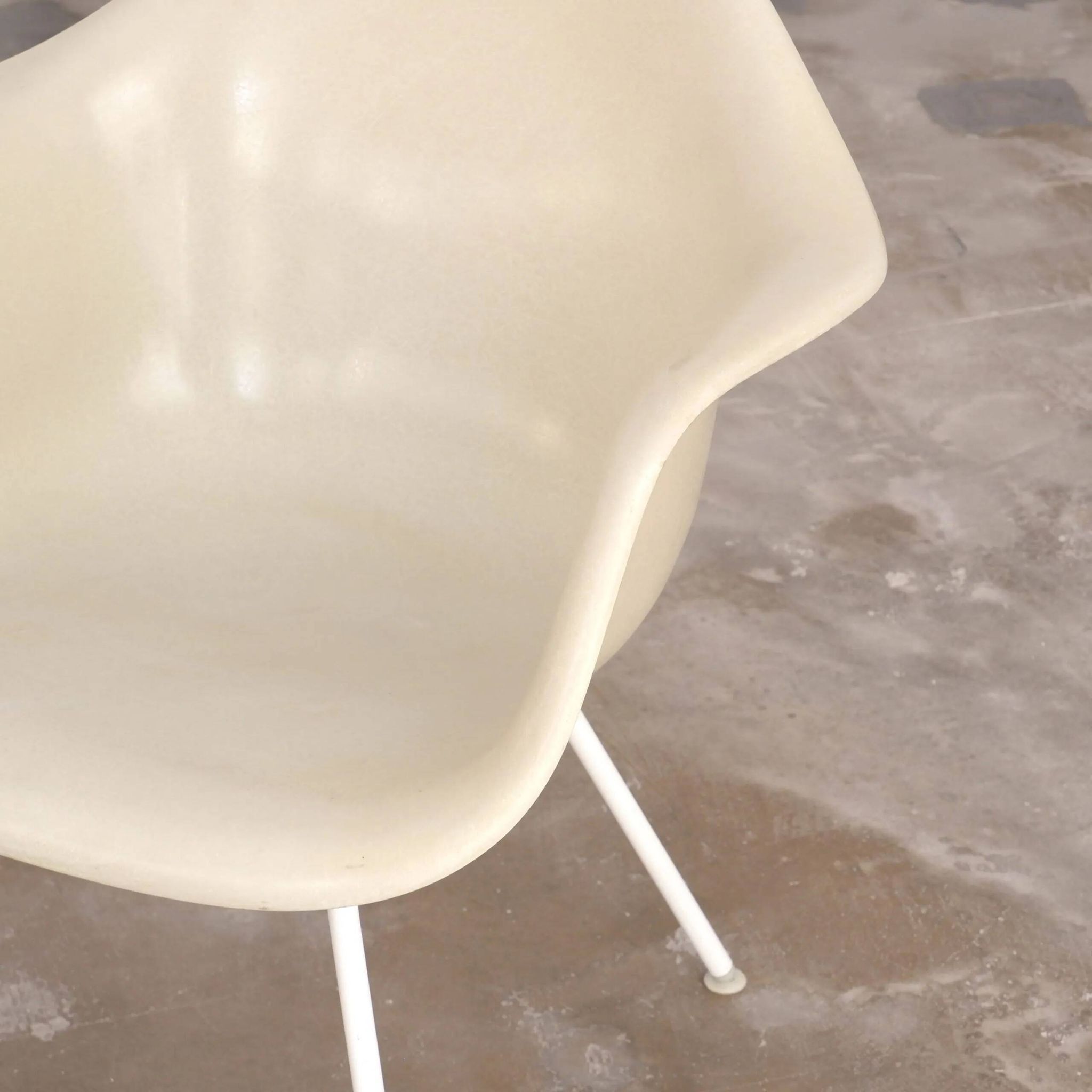Eames fiberglass armchair by herman miller with white lax base
