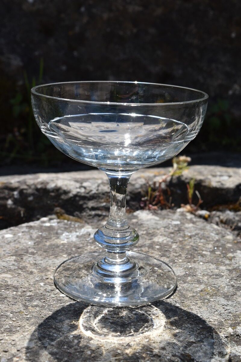 9 old champagne glasses in flat-waisted blown glass