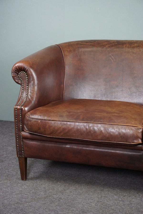 2-seater sofa in sheepskin decorative nails