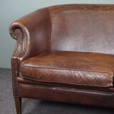 2-seater sofa in sheepskin decorative nails