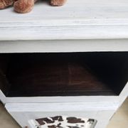Two solid wood bedside tables with calfskin decoration.