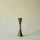 Set of three diabolo-shaped candle holders made of cast steel.