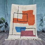 Traditional handmade wool Berber rug with colourful patterns.