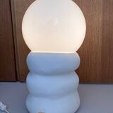 Large table lamp in off-white ceramic with an organic globe shape.