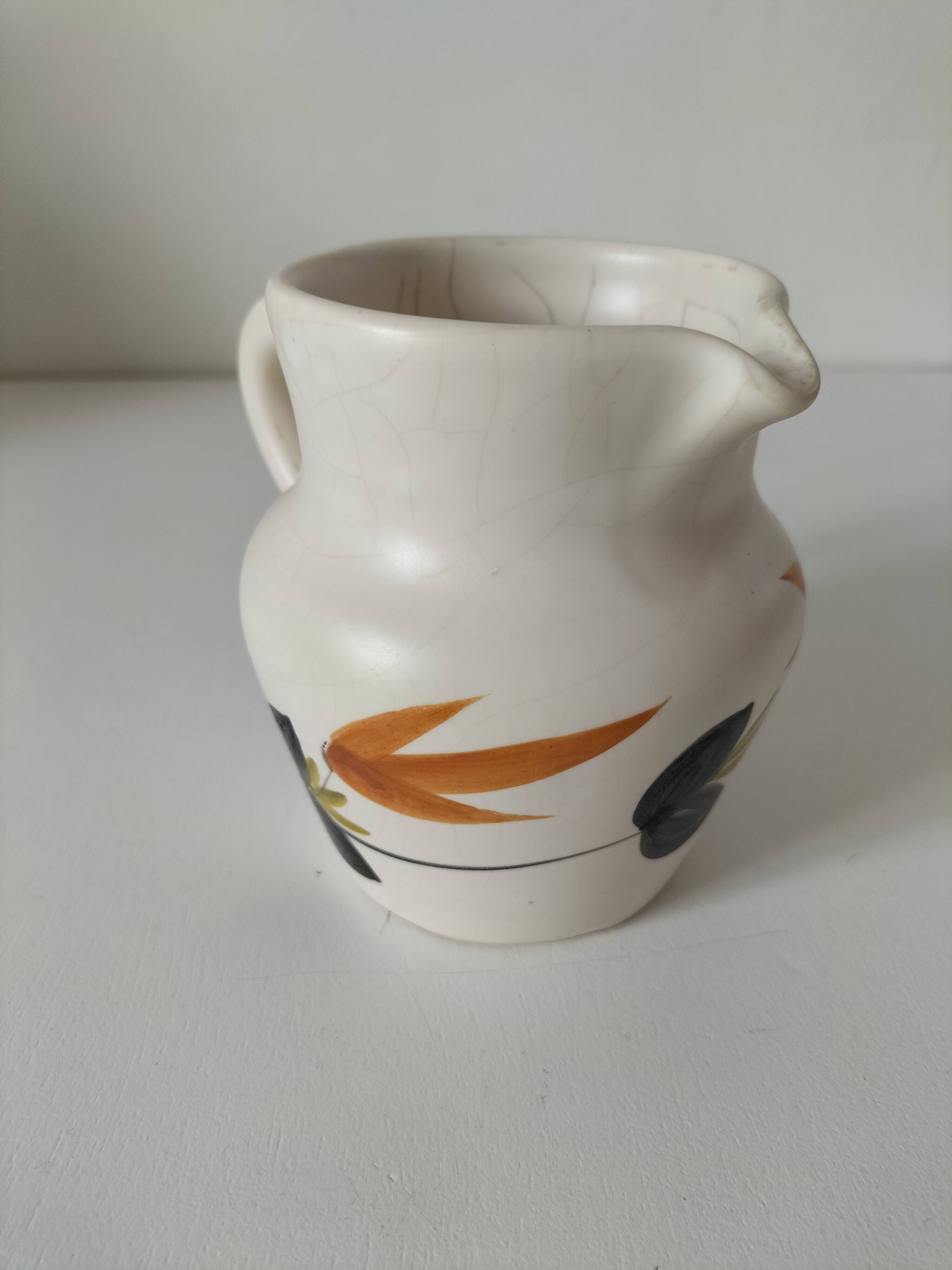 Vintage Marais pottery pitcher with orange floral decoration