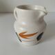 Vintage Marais pottery pitcher with orange floral decoration
