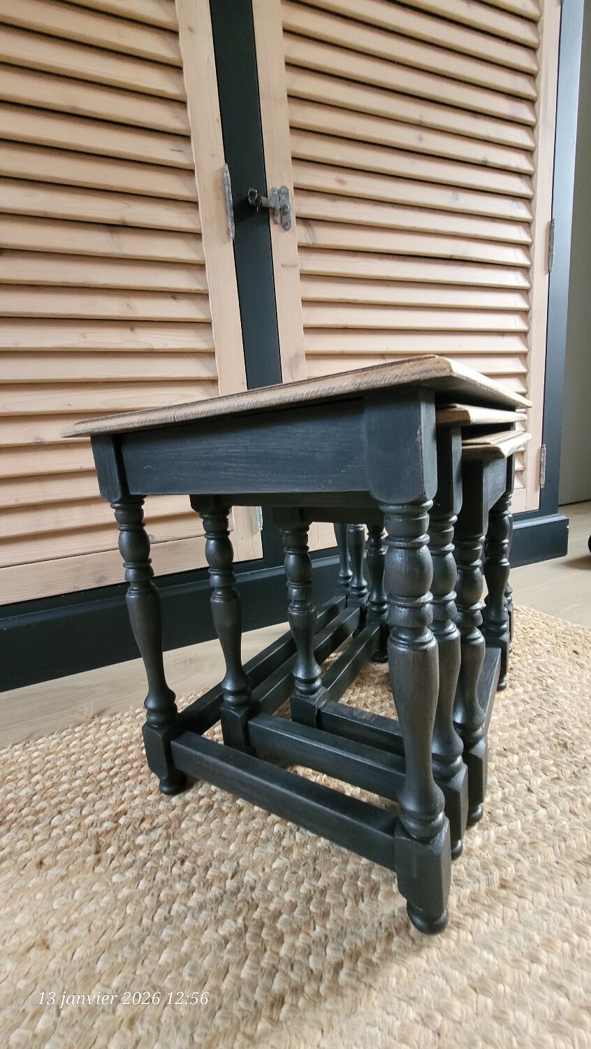Nest tables in wood and black.
