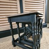 Nest tables in wood and black.