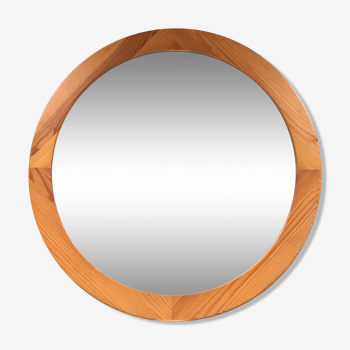 Round varnished pine mirror