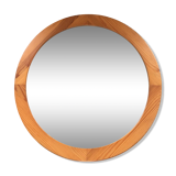 Round mirror in varnished pine