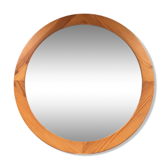 Round varnished pine mirror