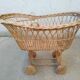 Rattan cradle for doll on vintage wheels