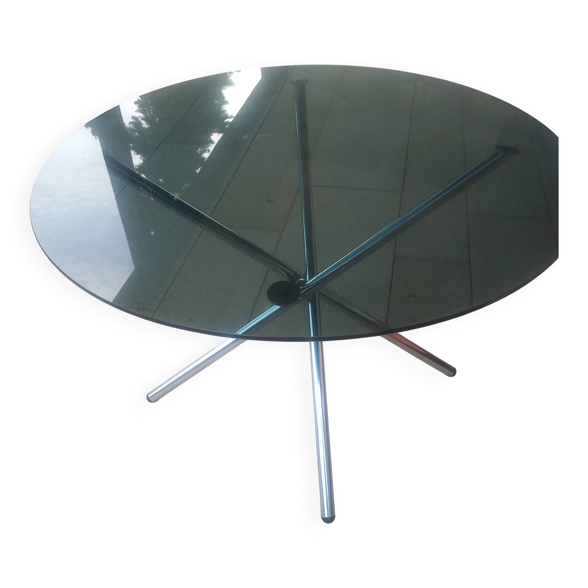 Round smoked glass table from the 70s. Foldable stainless steel legs.