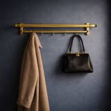 Vintage wall-mounted coat rack in anodised gold aluminium with hat holder.