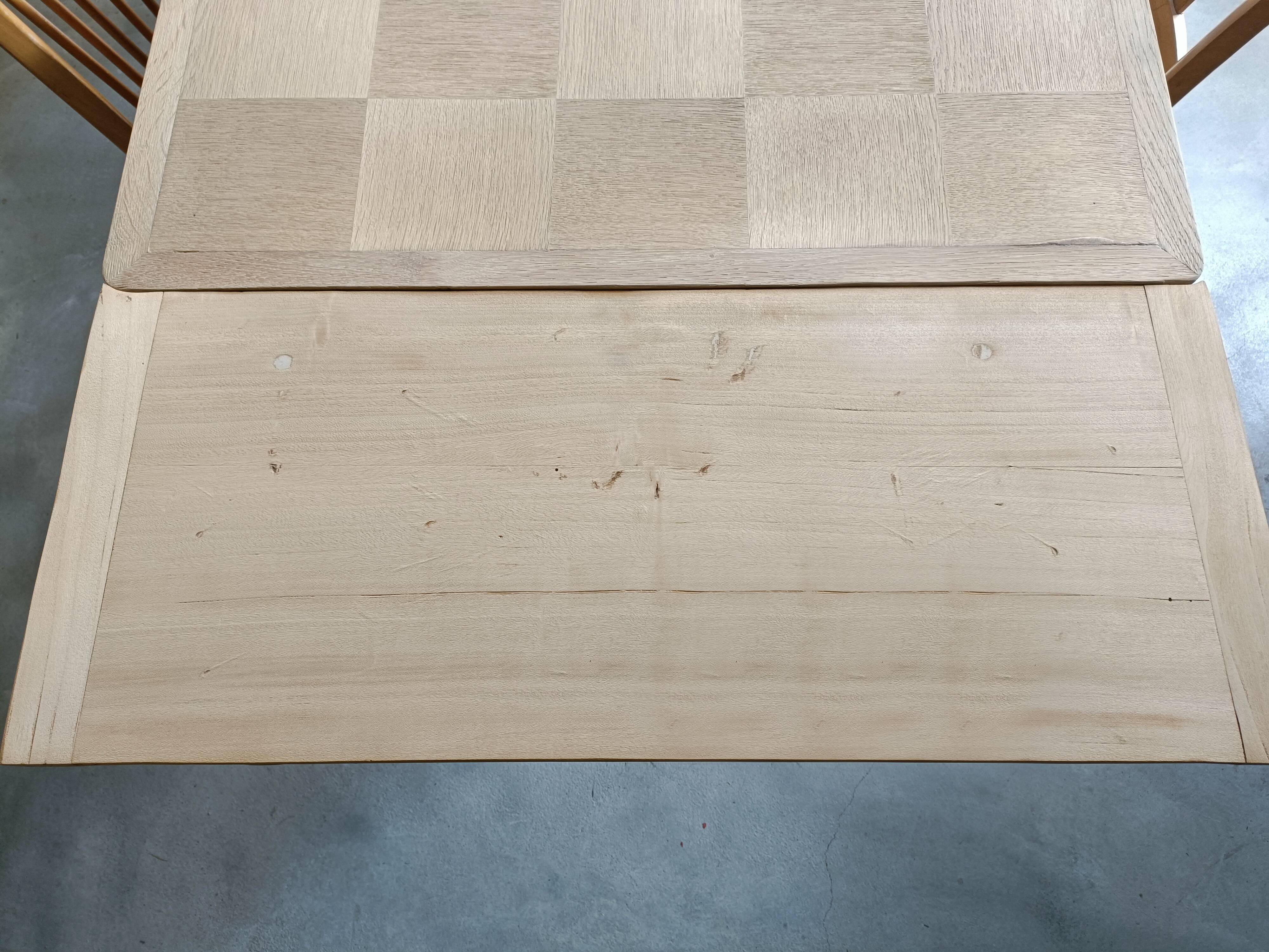 Oak dining table with a checkerboard top and extensions.