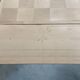 Oak dining table with a checkerboard top and extensions.