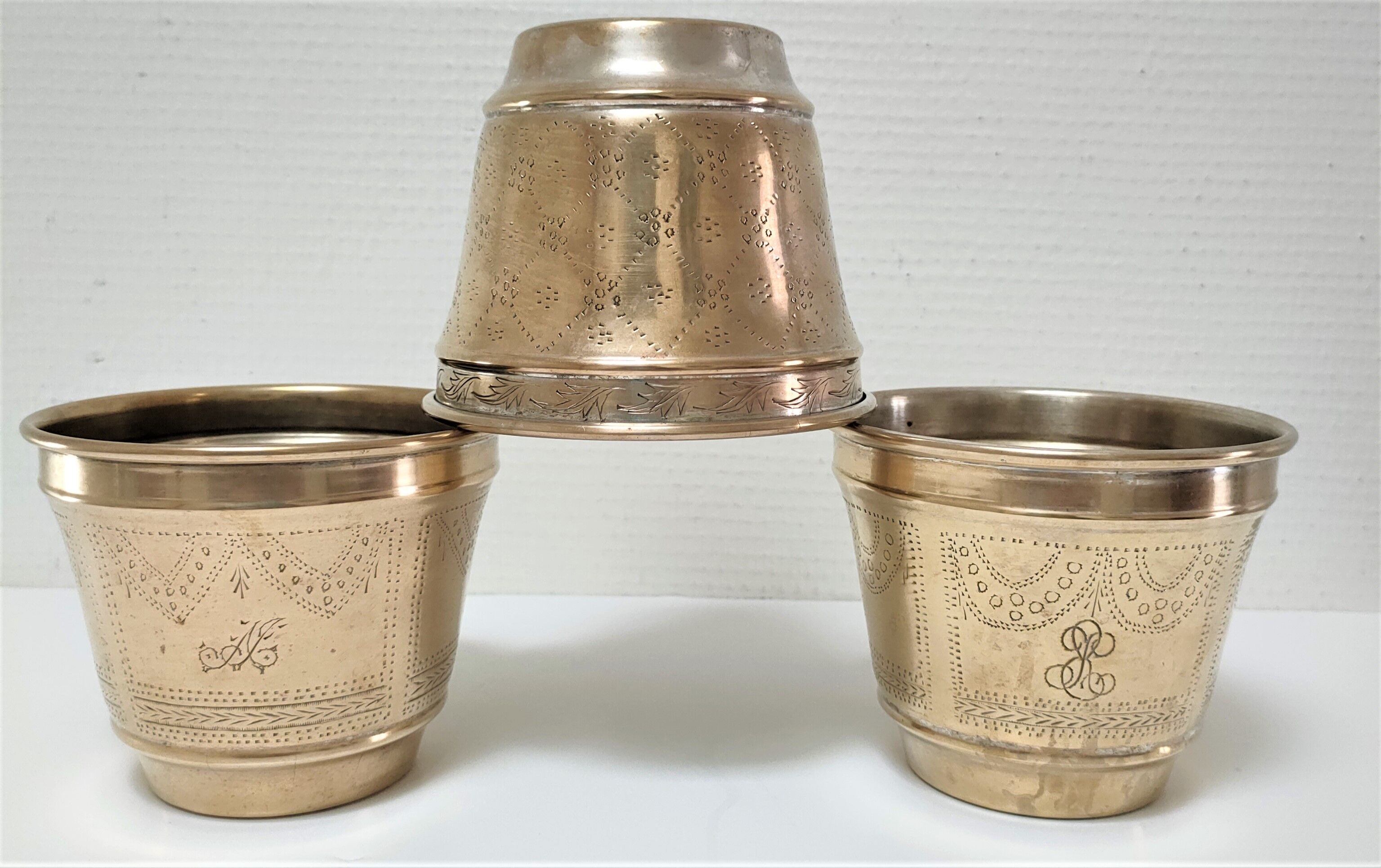 Three pot covers brass silver cover golden patina monogram early twentieth century