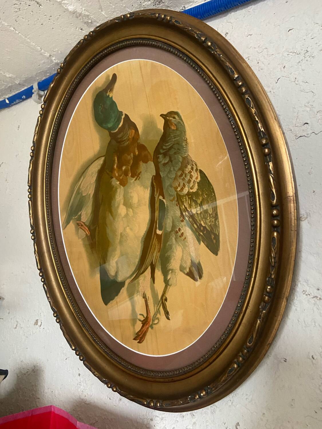 Antique oval frame with an oil painting of green collars