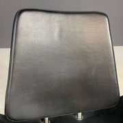 Alipes black swivel salon chair with chrome star base by Giorgetto Giugiaro