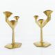 Pair of modernist three-armed solid brass candlesticks, circa 1960