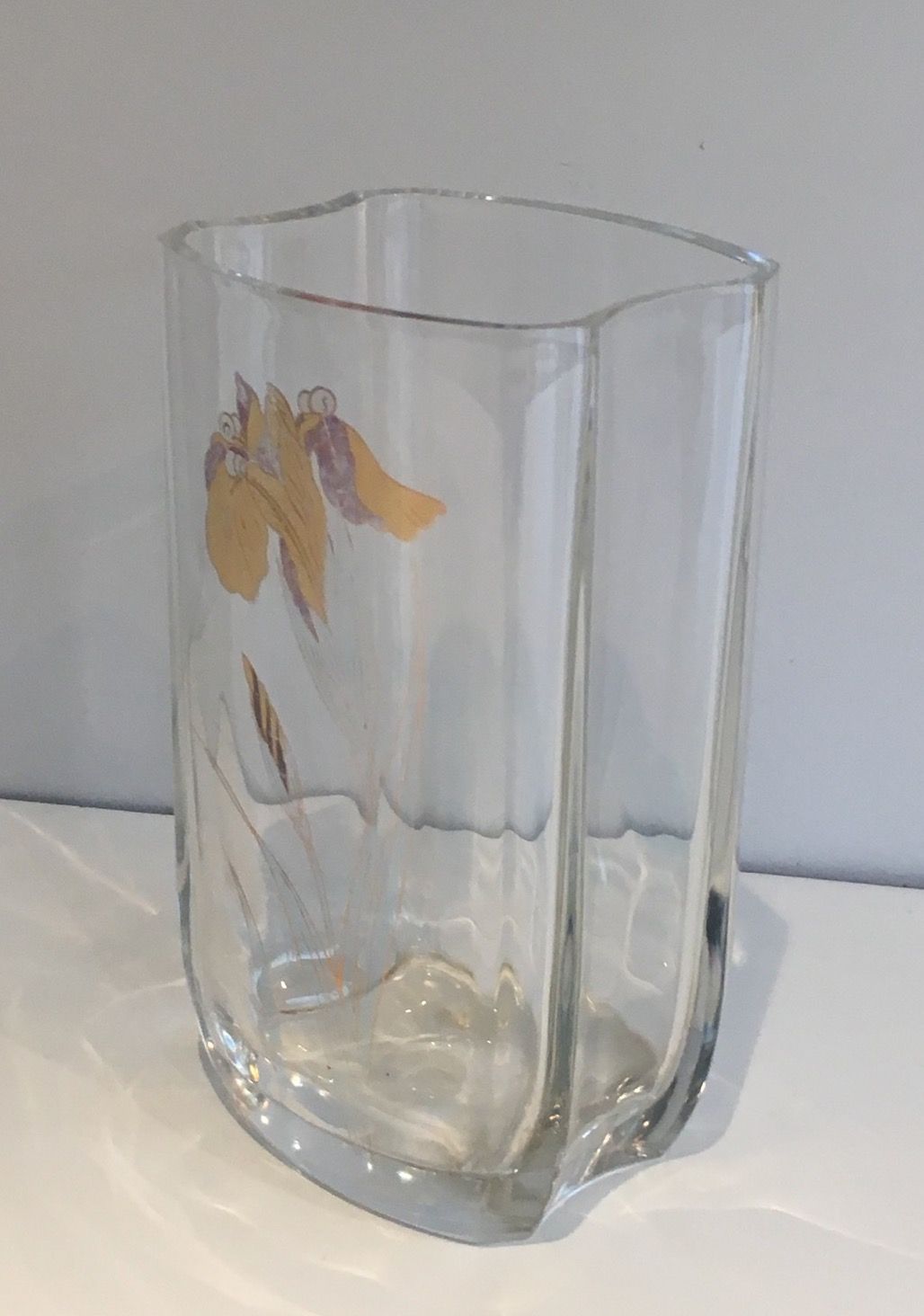 Glass vase with a decoration of a golden flower, around 1970.