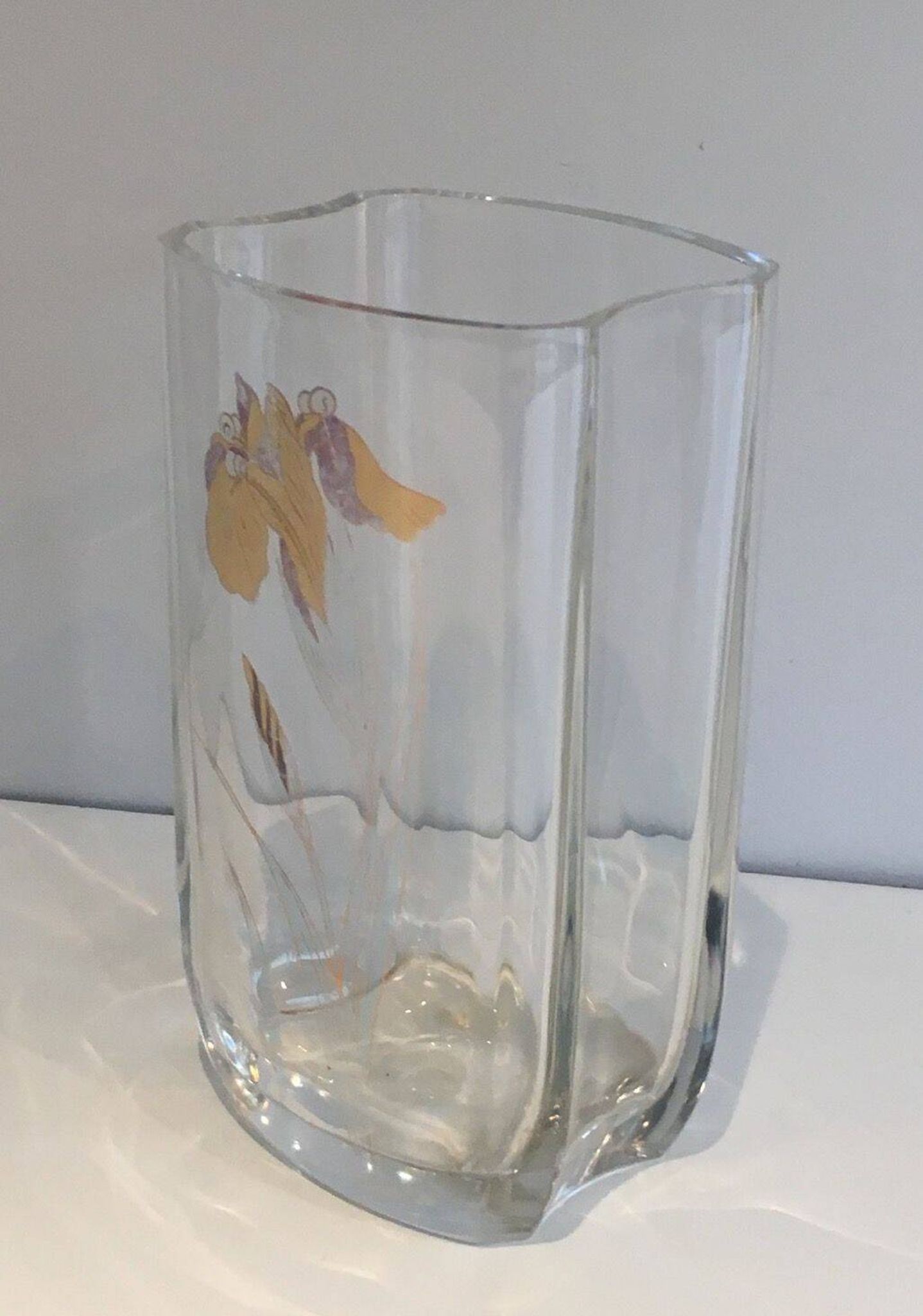 Glass vase with a decoration of a golden flower, around 1970.