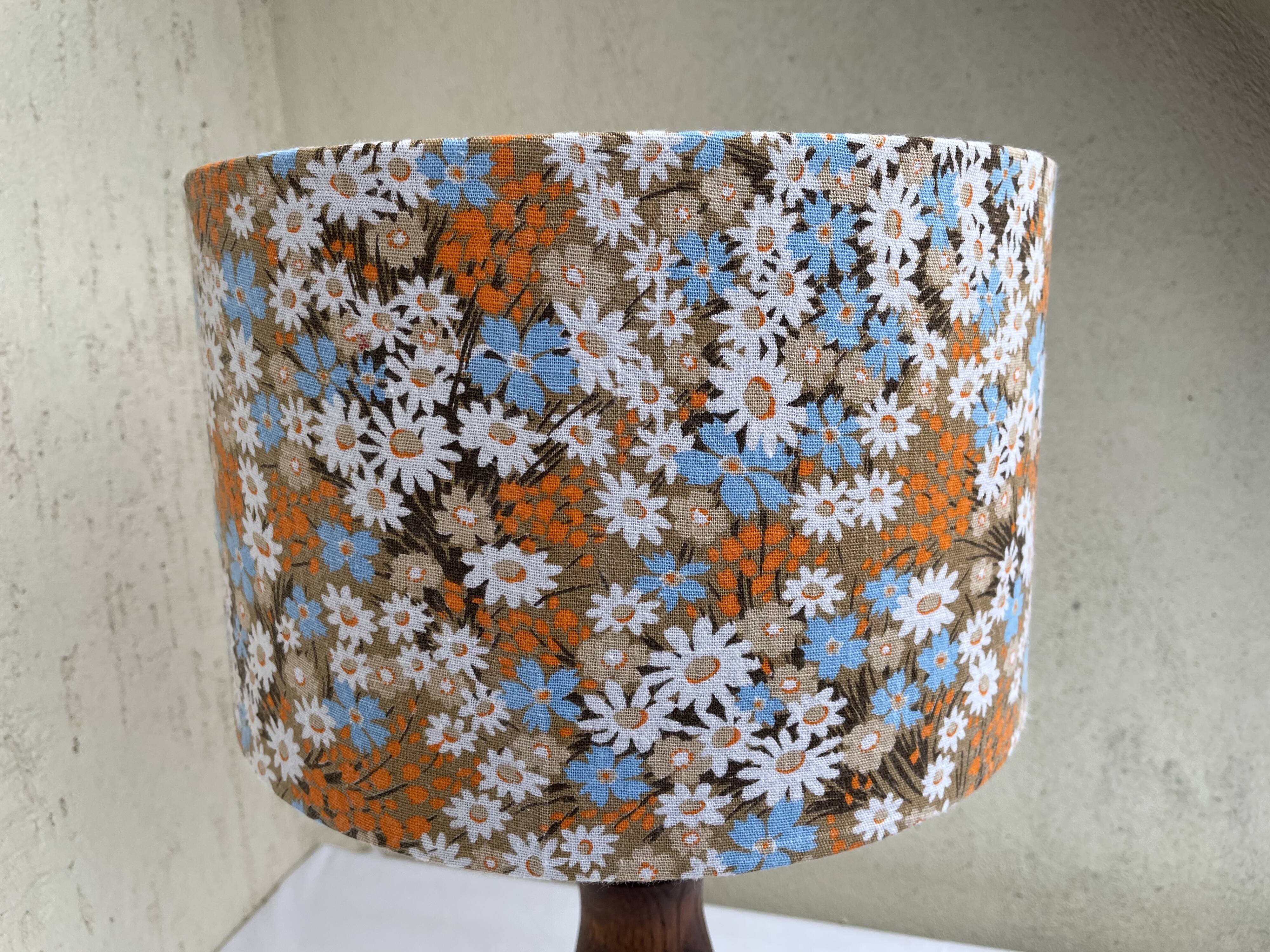 Vintage turned wood table lamp with floral drum shade.