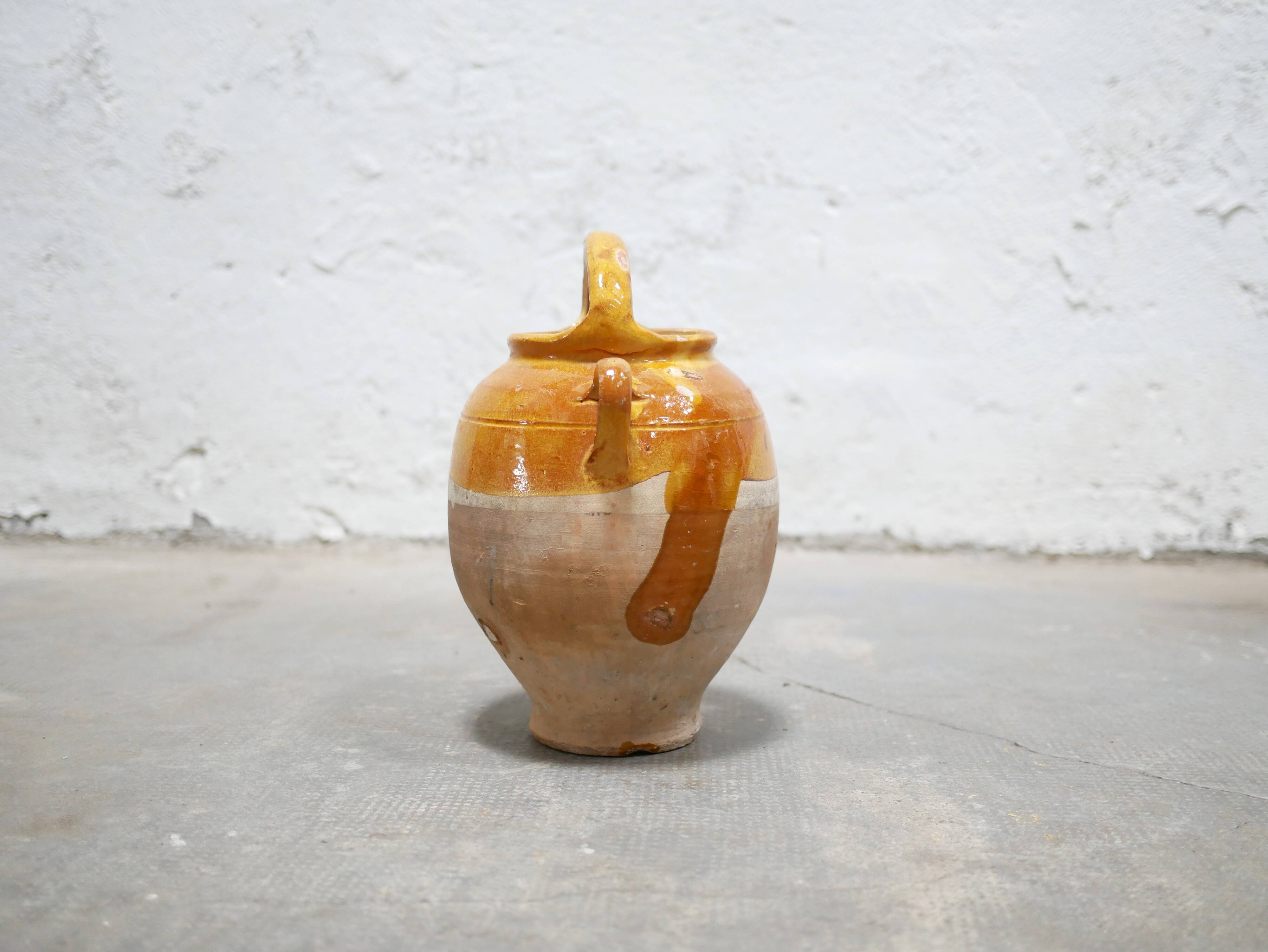 Old gargoulette pot in glazed terracotta