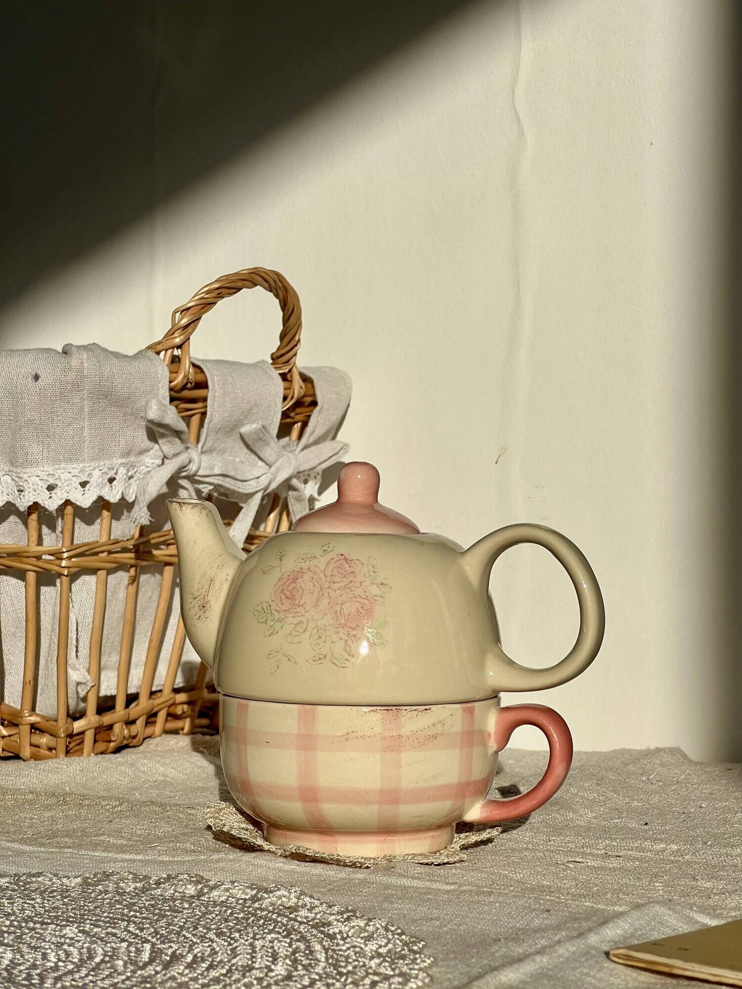 Vintage porcelain teapot and cup set with pink and beige floral and gingham pattern