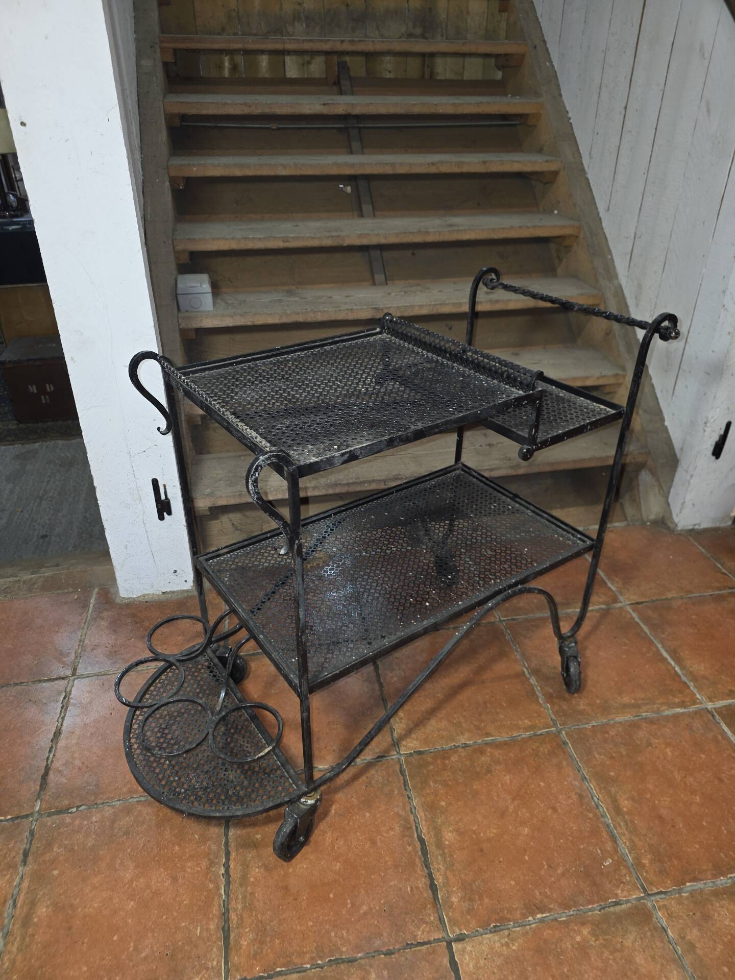 Perforated wrought iron rolling dessert trolley