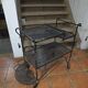 Perforated wrought iron rolling dessert trolley