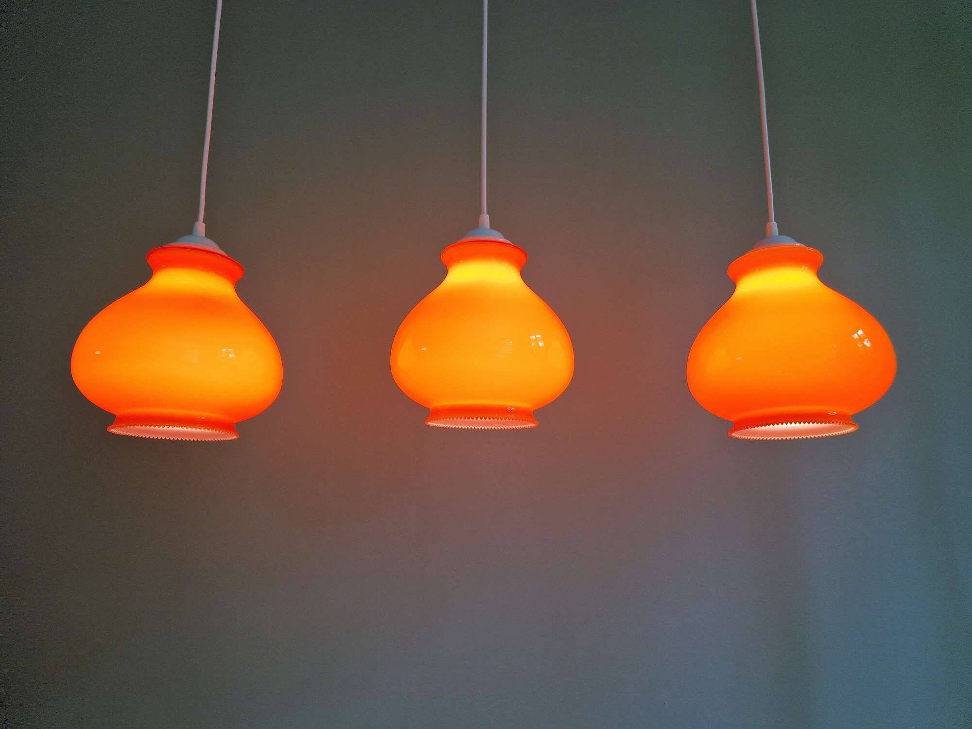Trio of vintage orange opaline pendant lights, 1960-70