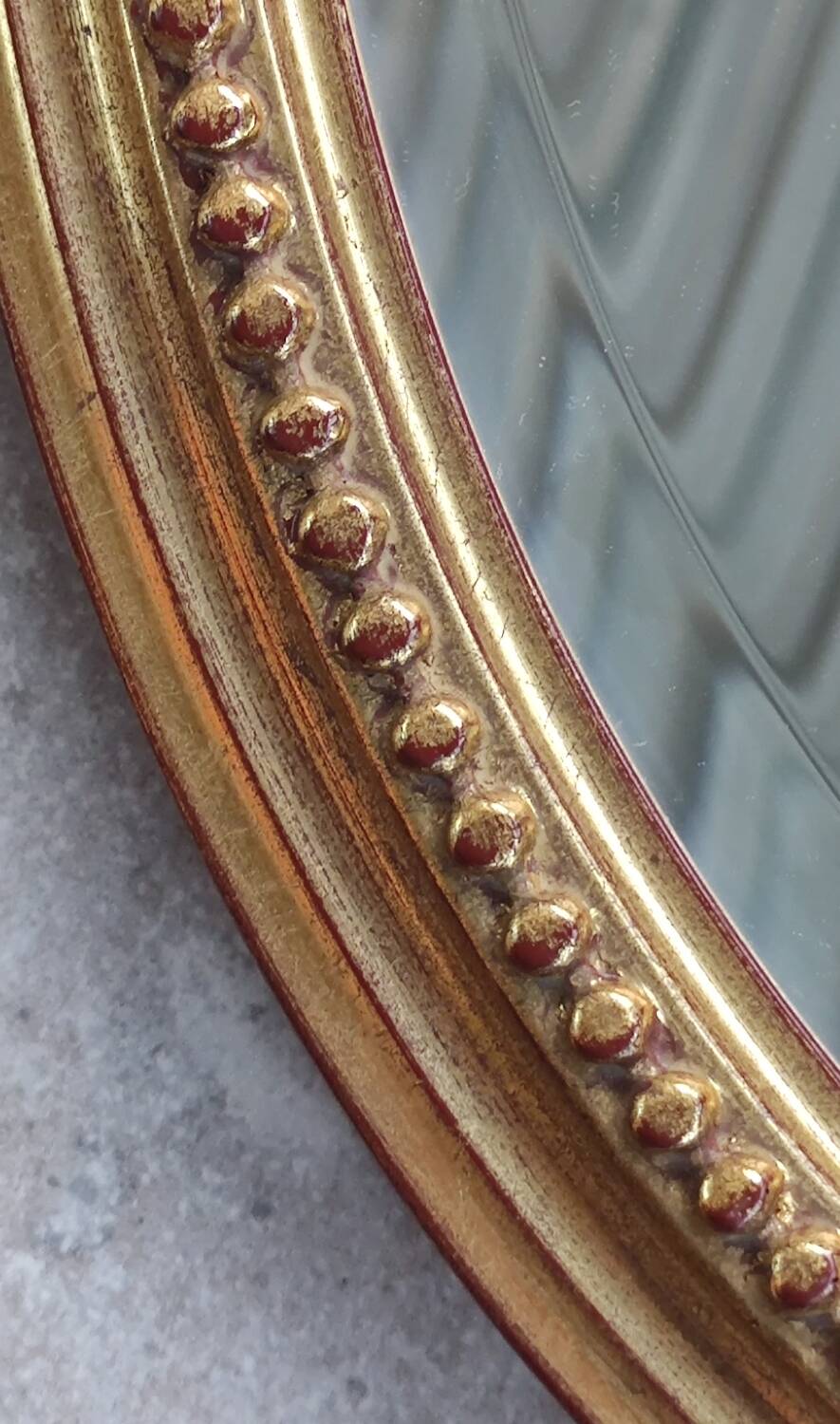 Old oval beveled golden mirror