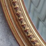 Old oval beveled golden mirror