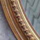 Old oval beveled golden mirror