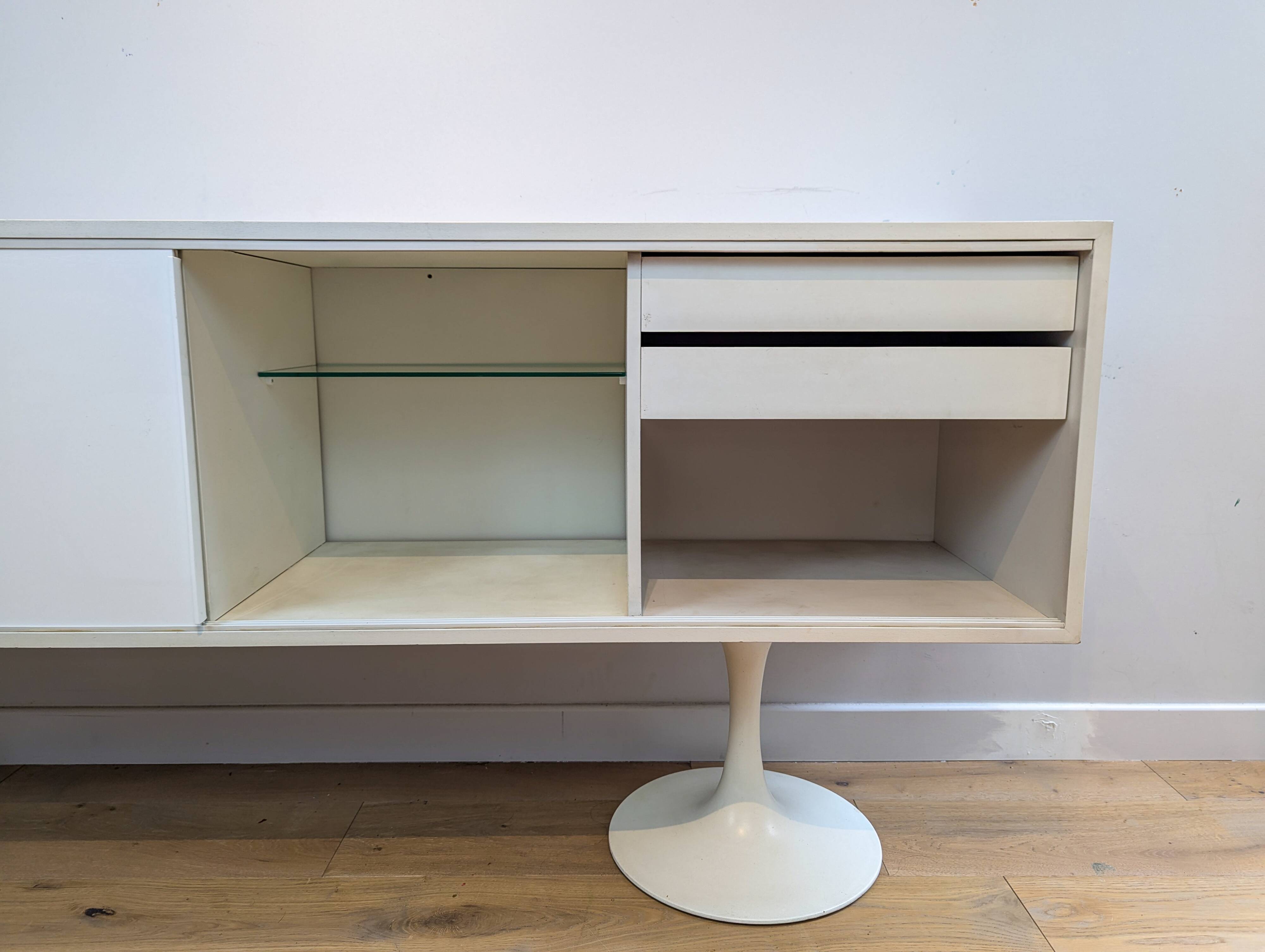 A vintage mid century space age sideboard with white sliding doors