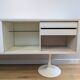 A vintage mid century space age sideboard with white sliding doors