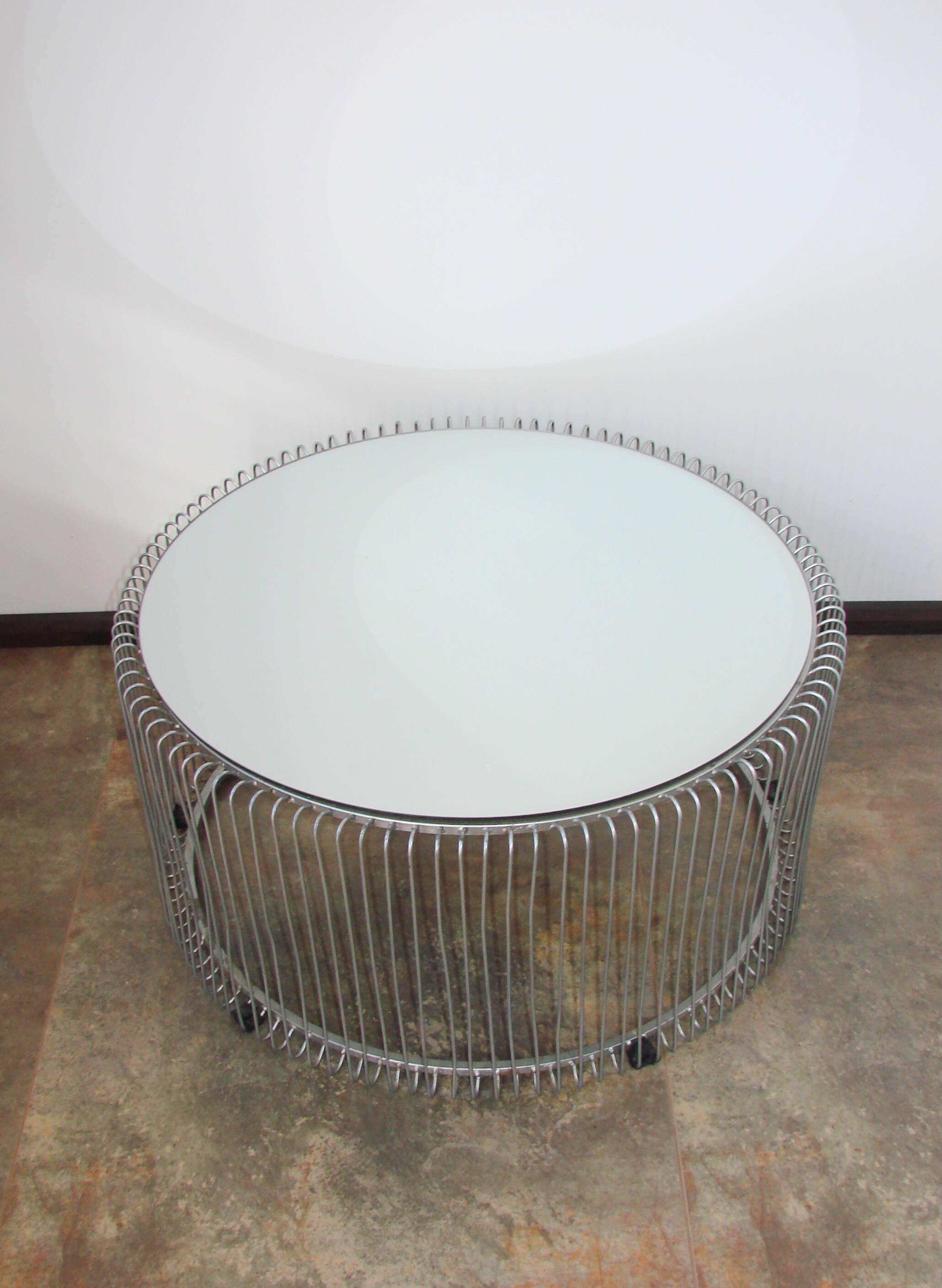 A round coffee table with a mirrored top, from the 1990s.