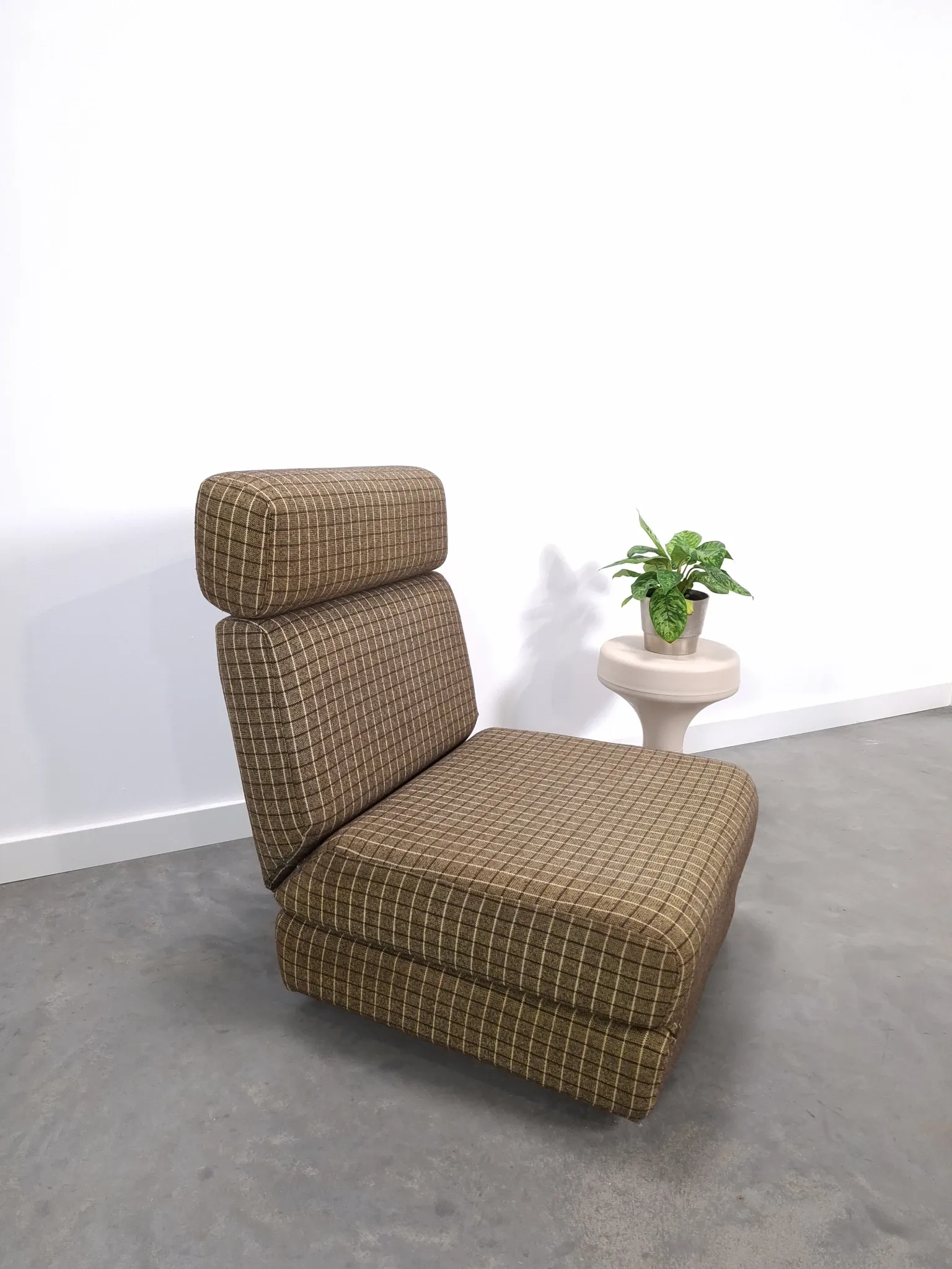 Vintage pull-out sofa bed, brown checked lounge chair with chrome.