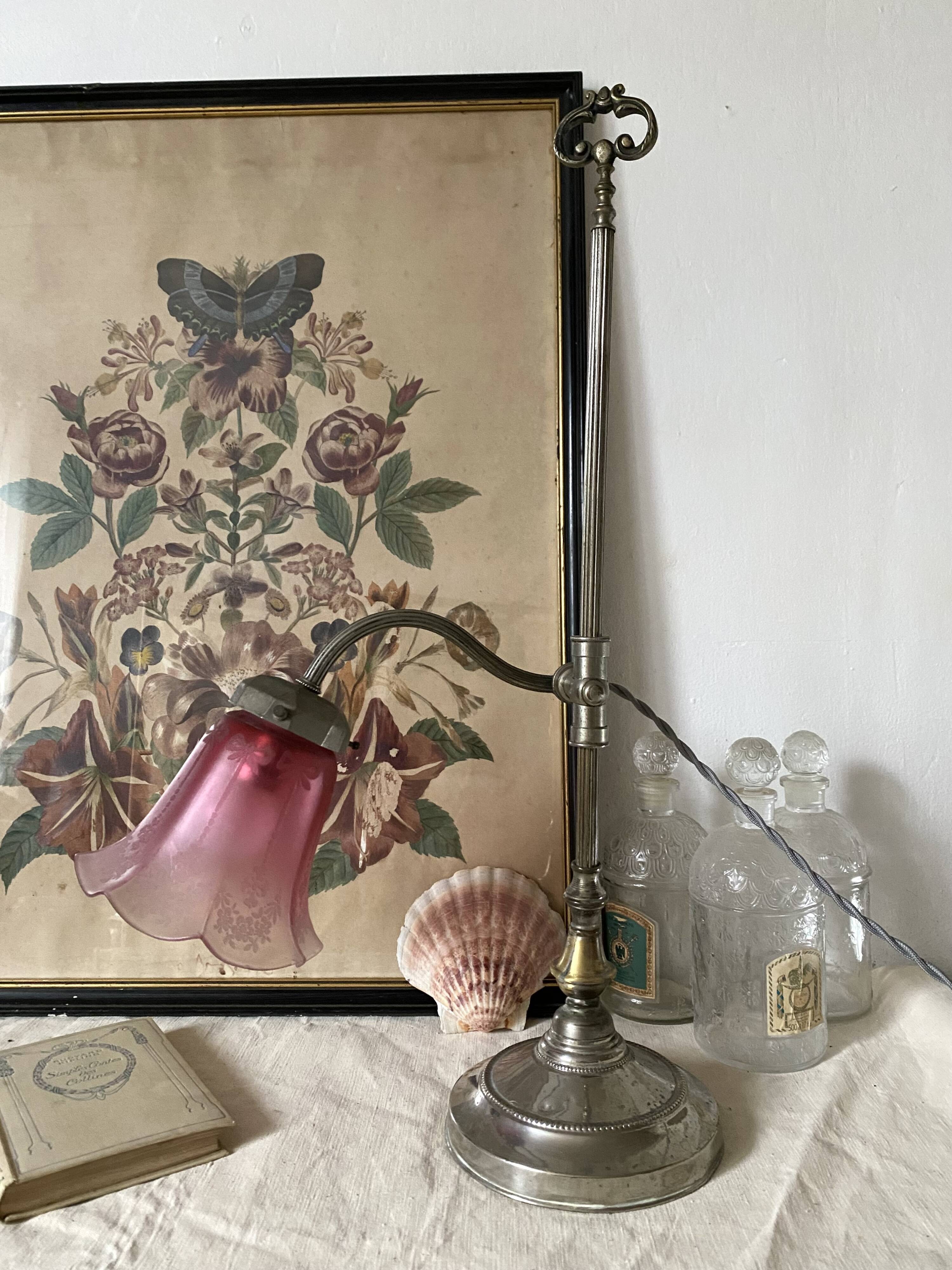 Antique jeweller's lamp, silver-plated base, frosted pink glass shade.