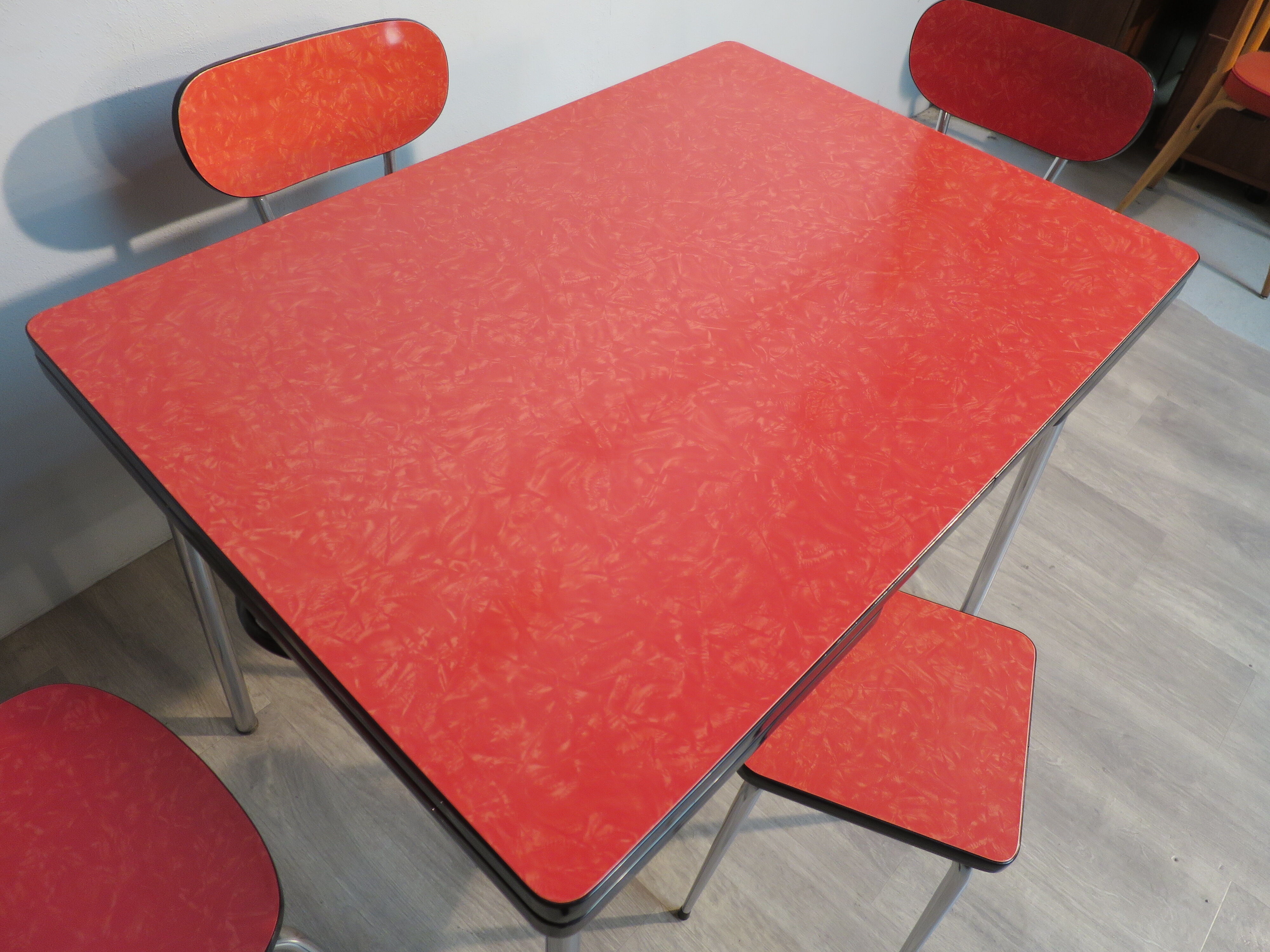 Table, 3 chairs and red formica stool