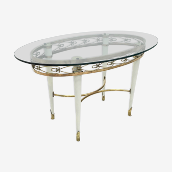 Brass coffee table with an oval glass top