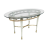 Brass coffee table with an oval glass top