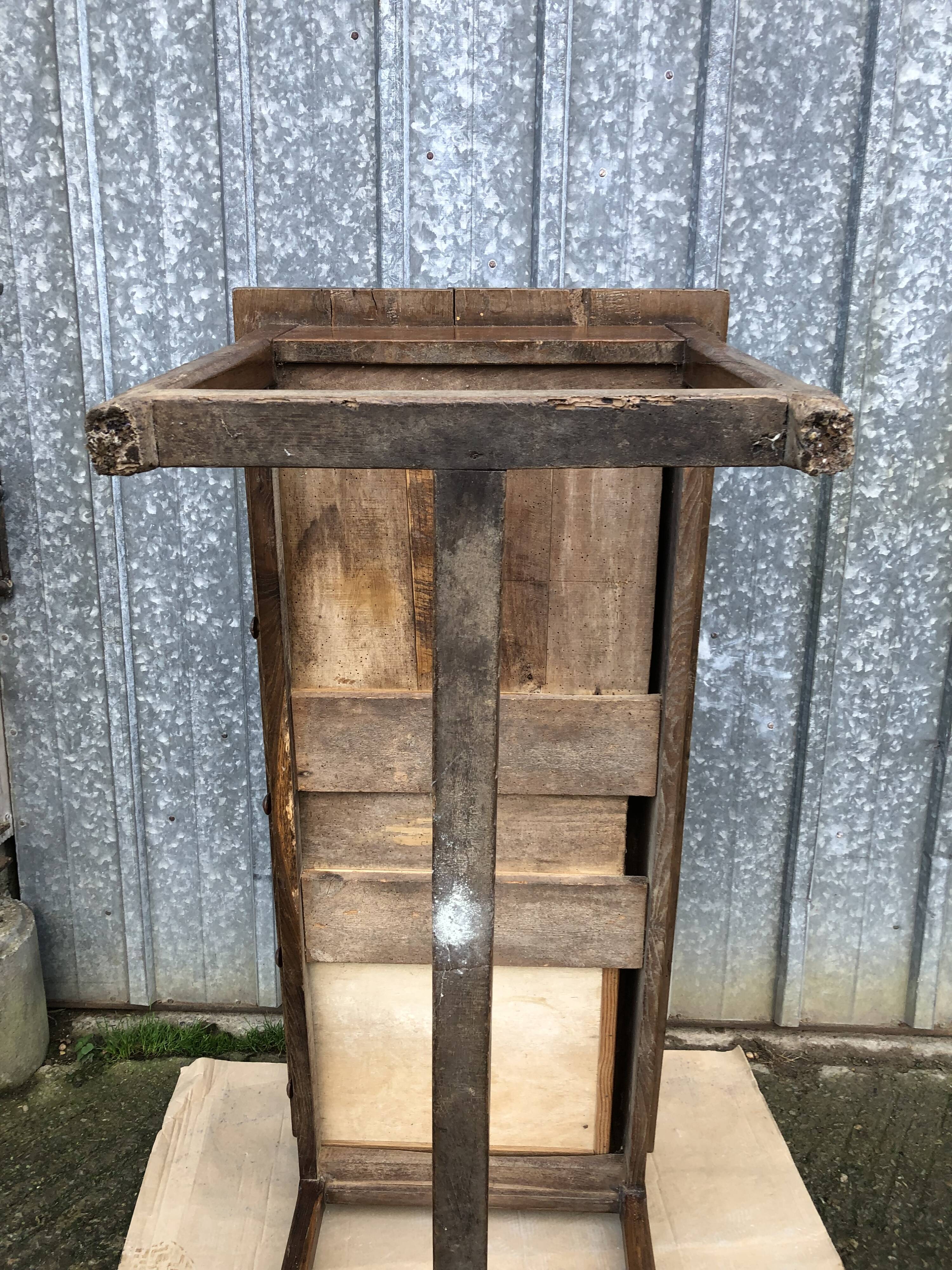 Old chestnut table with 3 front drawers and a cat bar.